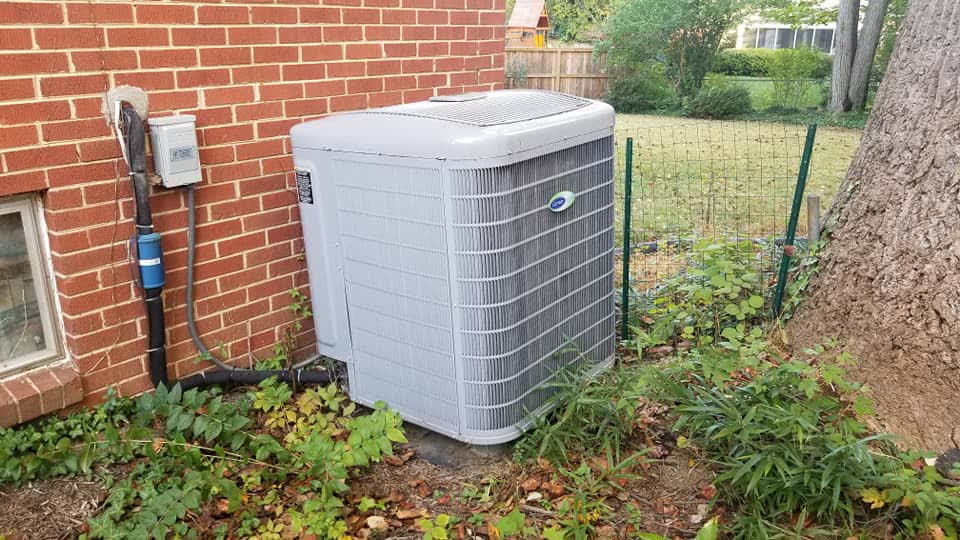 Condenser against brick wall